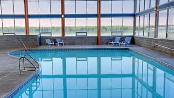 Relax by the pool with a serene view of the lake through large windows.