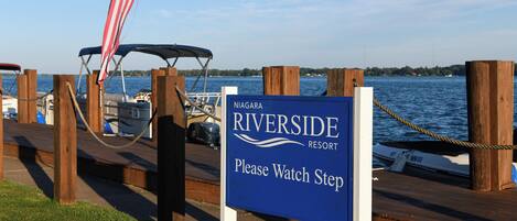 A sign for Riverside Resort with a warning to watch step.
