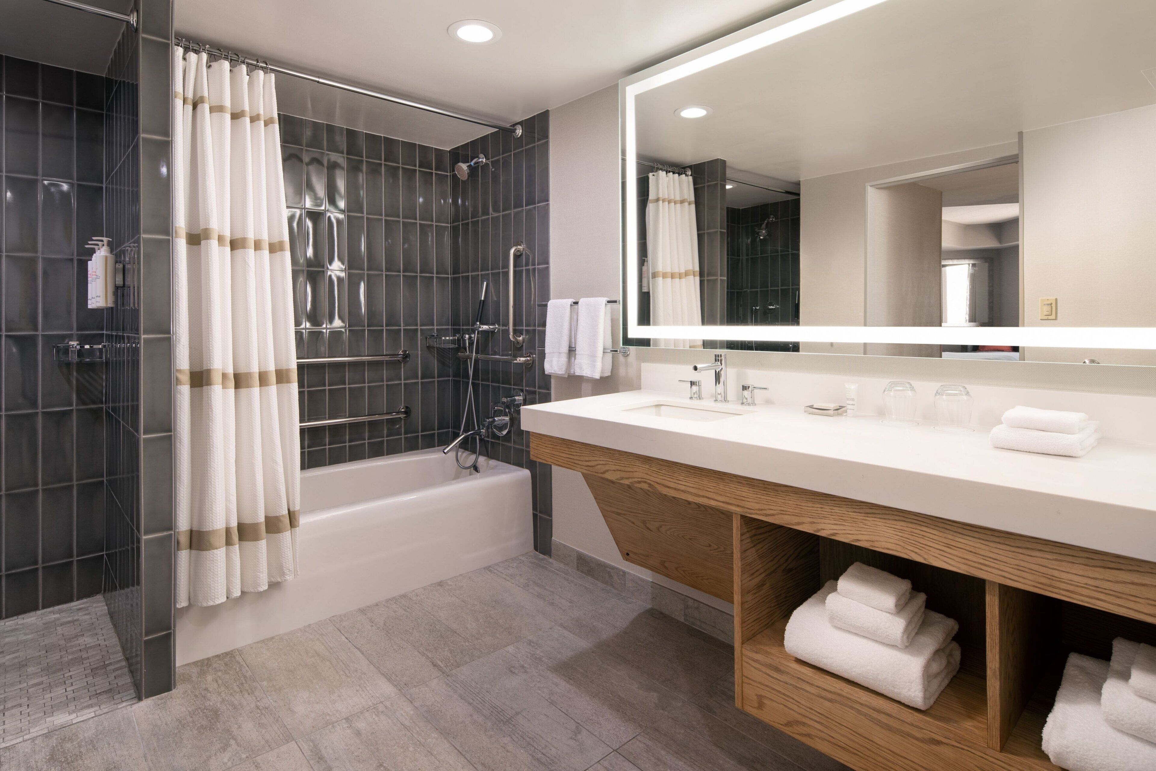 combined shower/bathtub, designer toiletries, hair dryer, towels