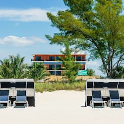 On the beach, white sand, free beach cabanas, beach towels