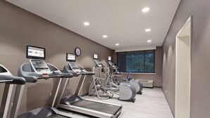 A gym with treadmills, elliptical machines, and a wall-mounted TV. - Holiday Inn Diamond Bar - Pomona by IHG (Diamond Bar)