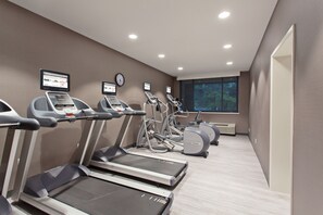A gym with treadmills, elliptical machines, and a wall-mounted TV. - Holiday Inn Diamond Bar - Pomona by IHG (Diamond Bar)