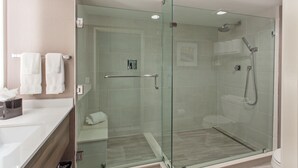 A modern bathroom with a glass-enclosed shower, a white sink, and a toilet. - Holiday Inn Diamond Bar - Pomona by IHG (Diamond Bar)