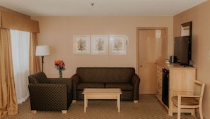 Suite, 1 King Bed with Sofa bed, Hot Tub | Living area | 42-inch flat-screen TV with cable channels, TV