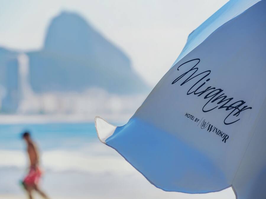 A close-up of a hotel sign with the name 'Miramar' and 'HOTEL BY WINDSOR' visible.