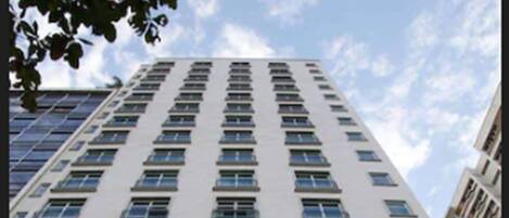 A tall hotel building with a sign reading "Minamax Hotel" at the bottom.