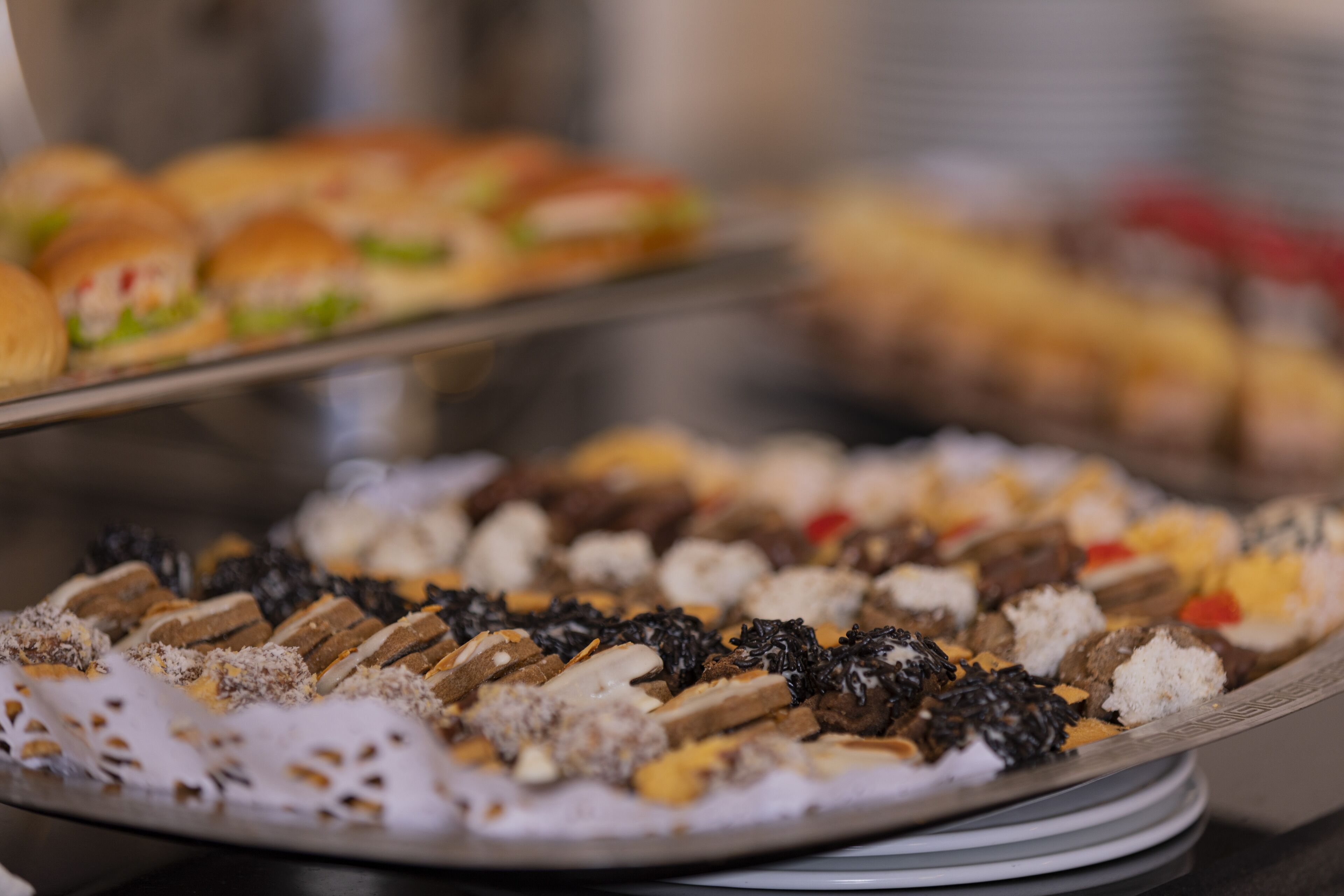 A buffet with various food items including cakes, pastries, and desserts.