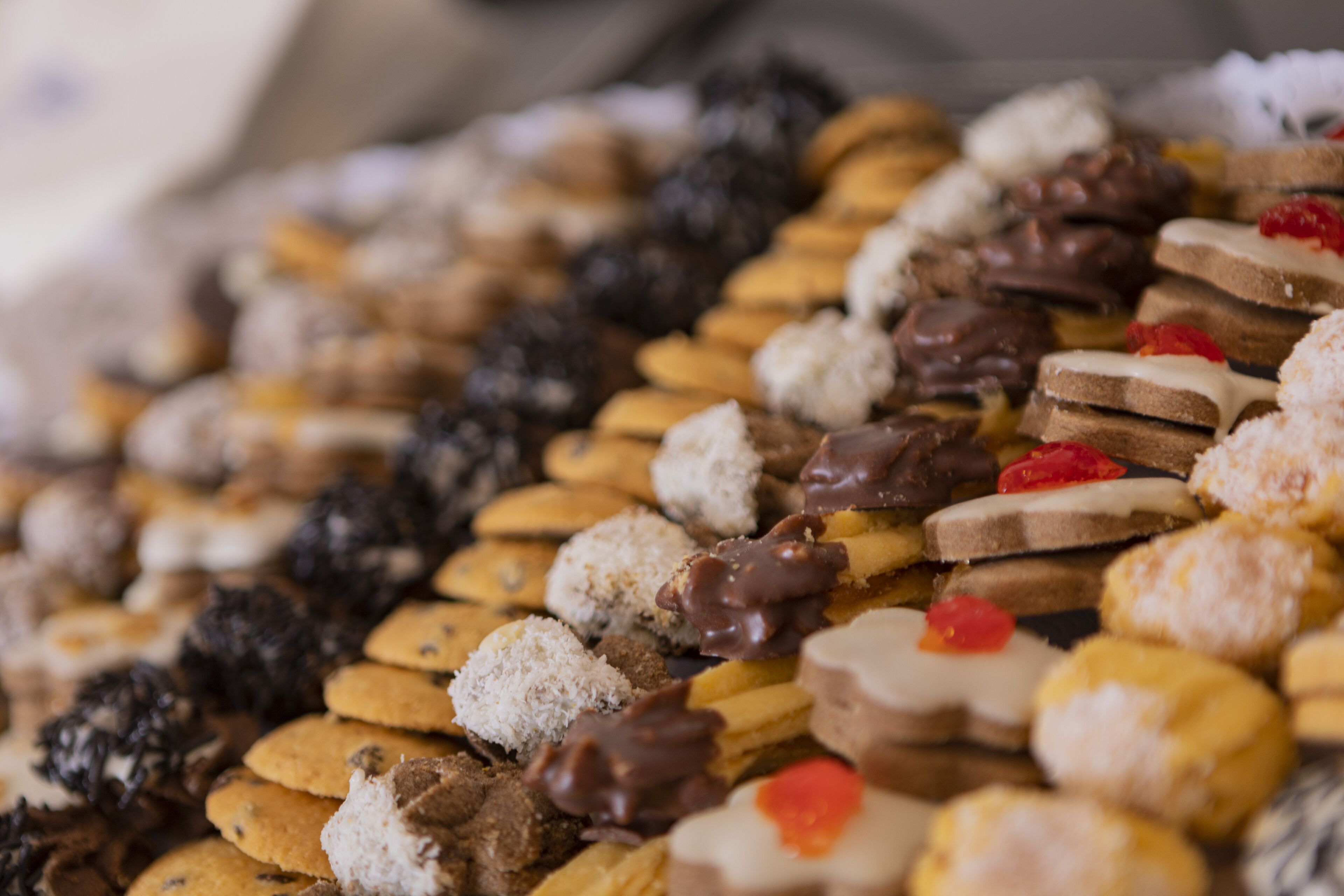 A variety of cookies and pastries on a tray.