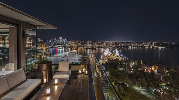 A night view from a balcony with a cityscape, including a bridge and waterfront buildings. - InterContinental Sydney by IHG (Sydney)