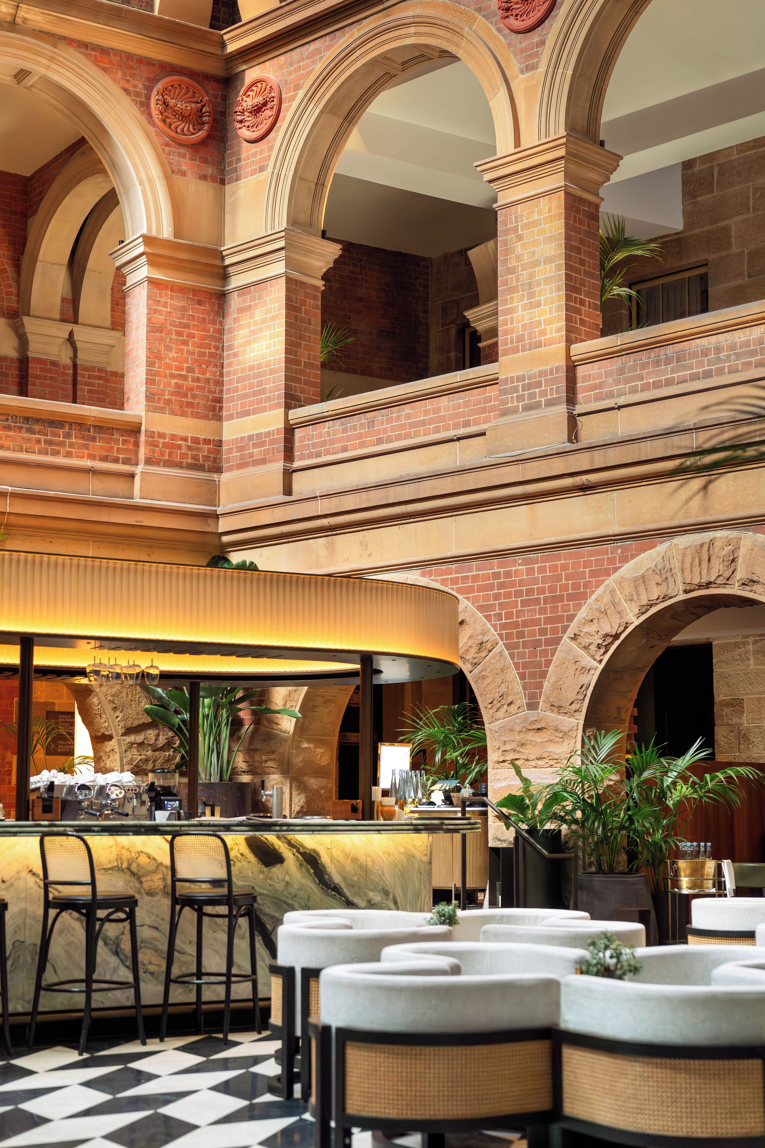 A spacious indoor area with a checkered floor, multiple seating arrangements, and a bar area.