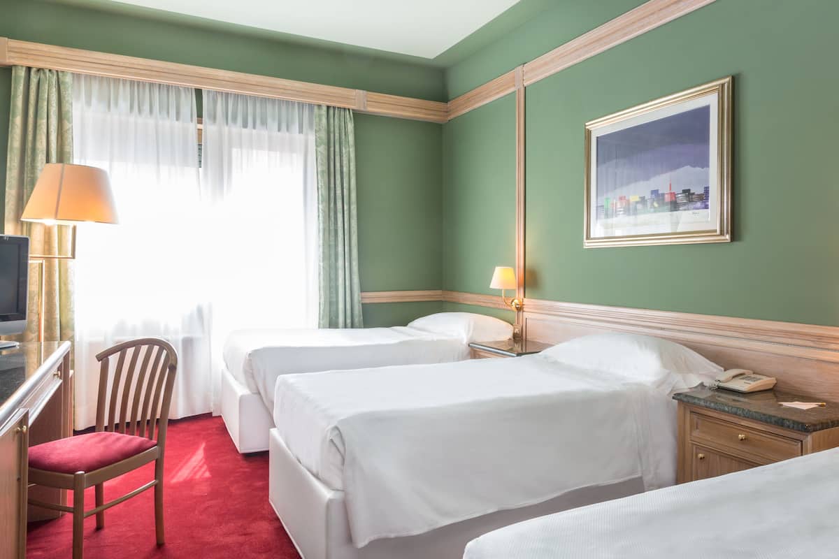 Classic Triple Room | Minibar, in-room safe, desk, blackout drapes