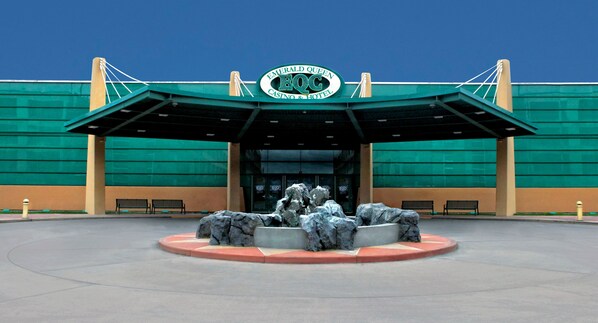 Welcome to the Emerald Queen Casino & Hotel, featuring a striking green facade and a grand entrance canopy.
