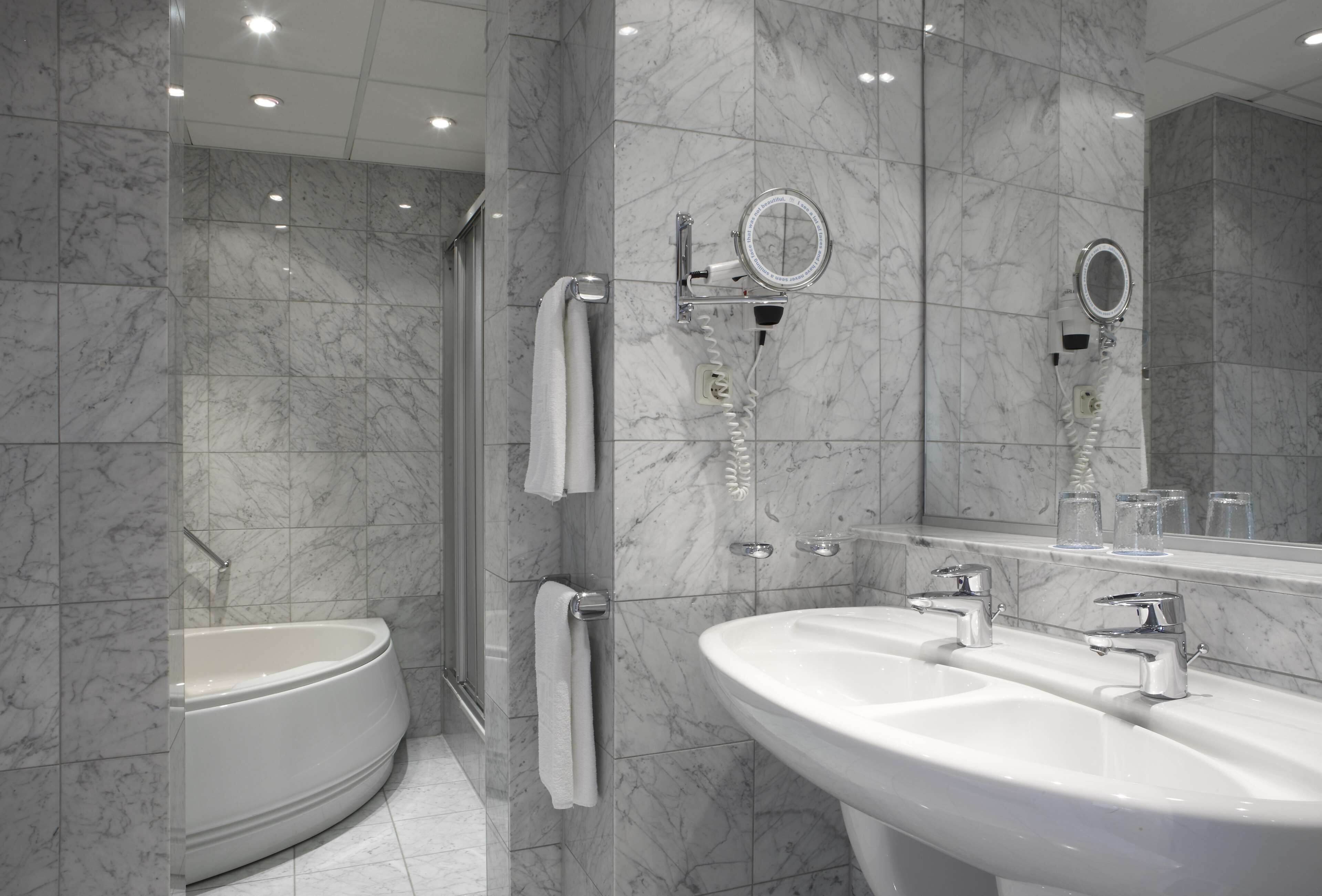 junior suite | bathroom | deep-soaking bathtub, rainfall showerhead, eco-friendly toiletries