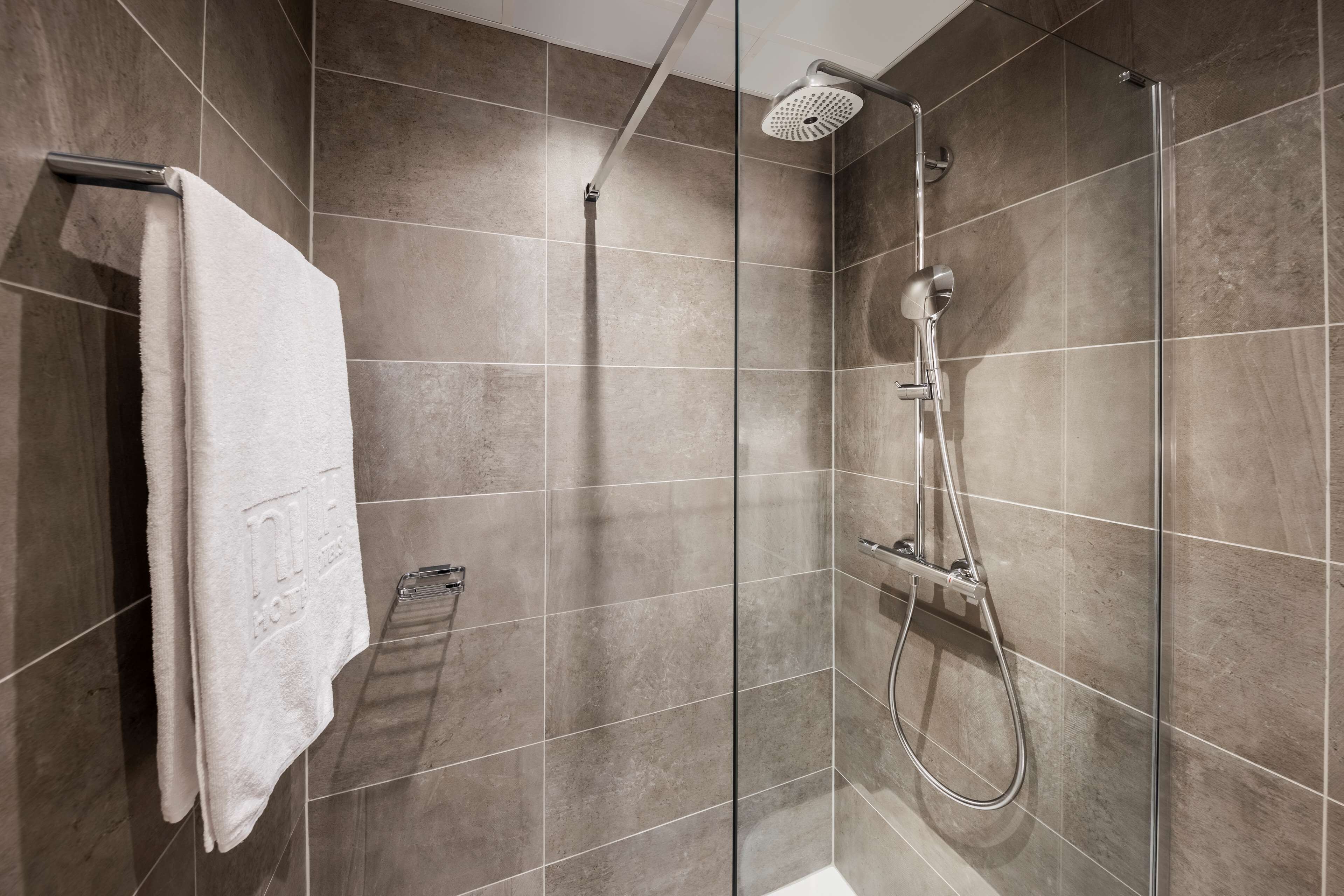 junior suite | bathroom | deep-soaking bathtub, rainfall showerhead, eco-friendly toiletries