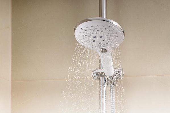 A showerhead with water flowing from it.