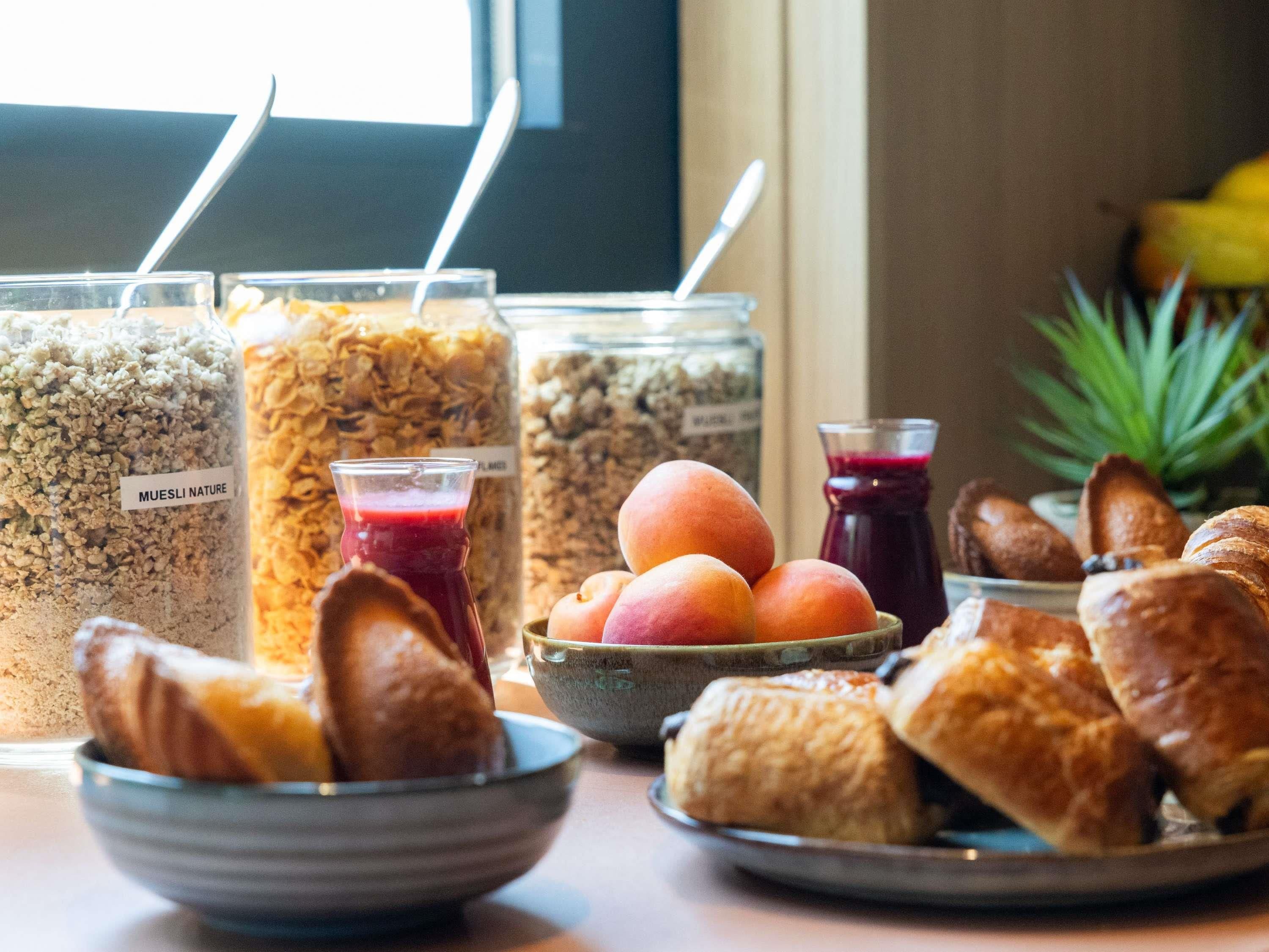 A breakfast buffet with various food items and drinks.