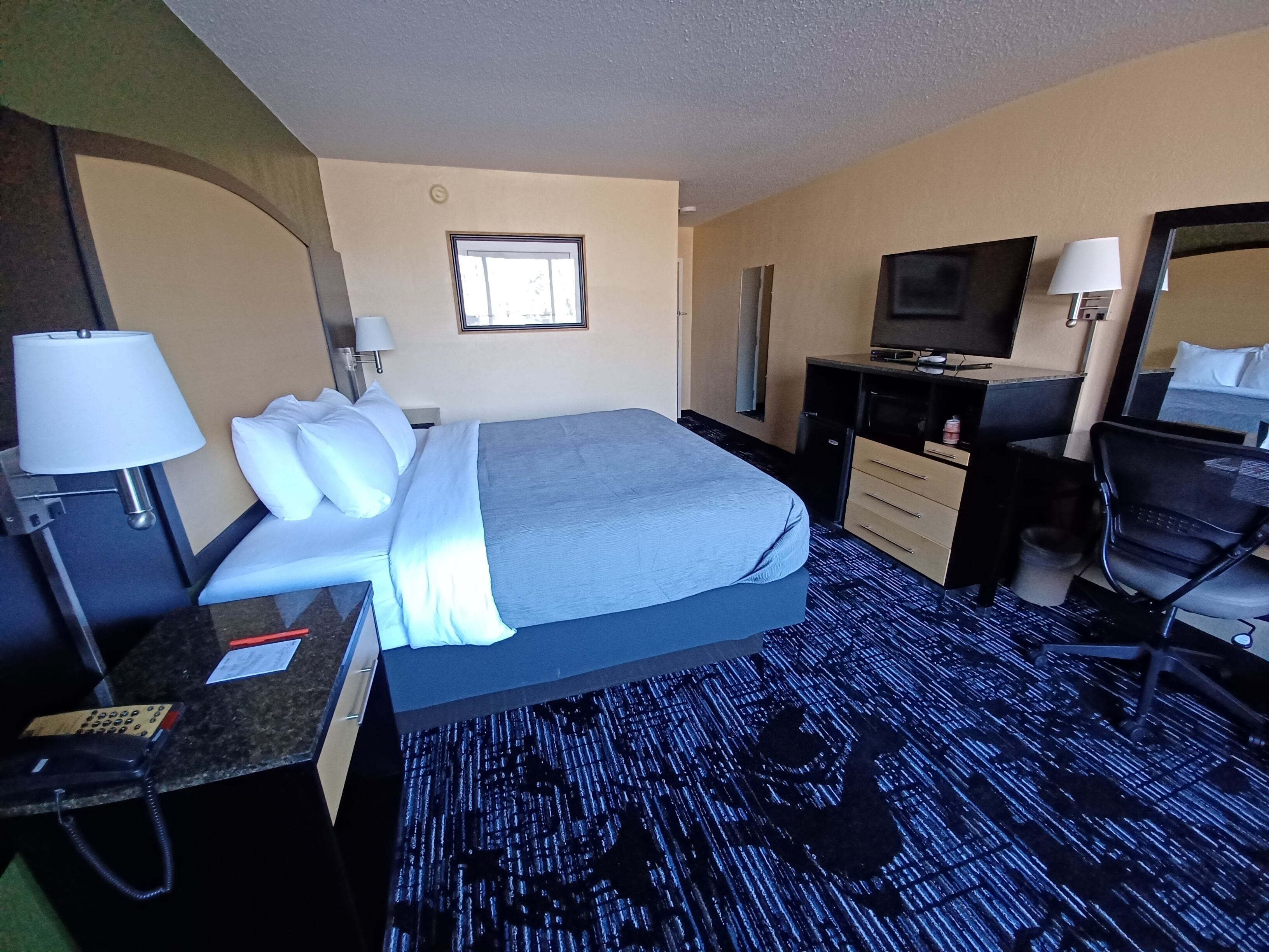 Premium bedding, desk, laptop workspace, iron/ironing board