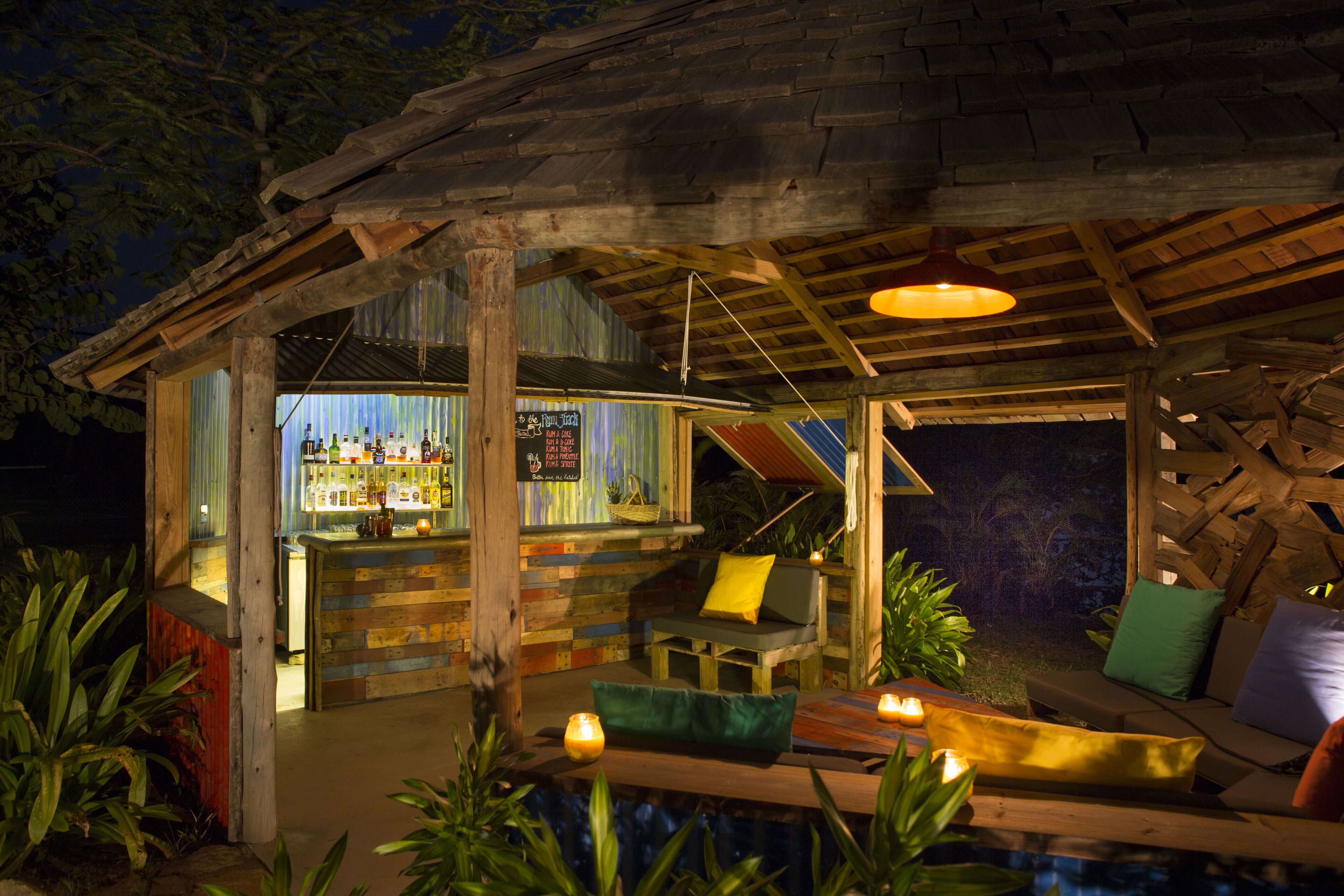 An outdoor bar area with wooden furniture and a bar counter.