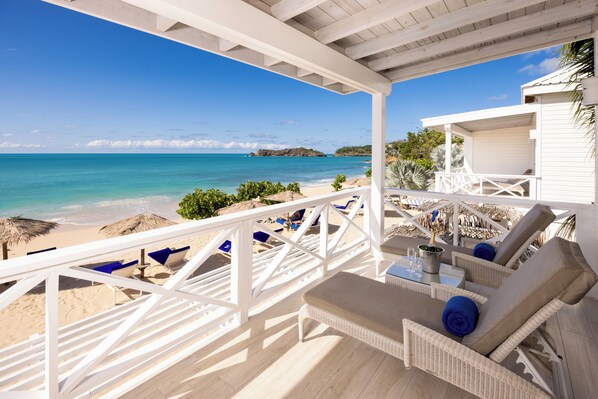 A beachside patio with wicker furniture, a pool table, and a view of the ocean. - Galley Bay Resort & Spa - All inclusive (St. John's)