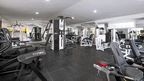 A gym with various exercise equipment, including treadmills and weight machines.