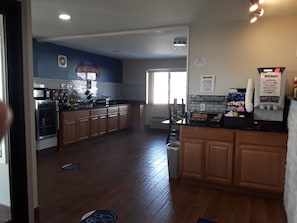A kitchen with wooden cabinets, a microwave, and a coffee machine.