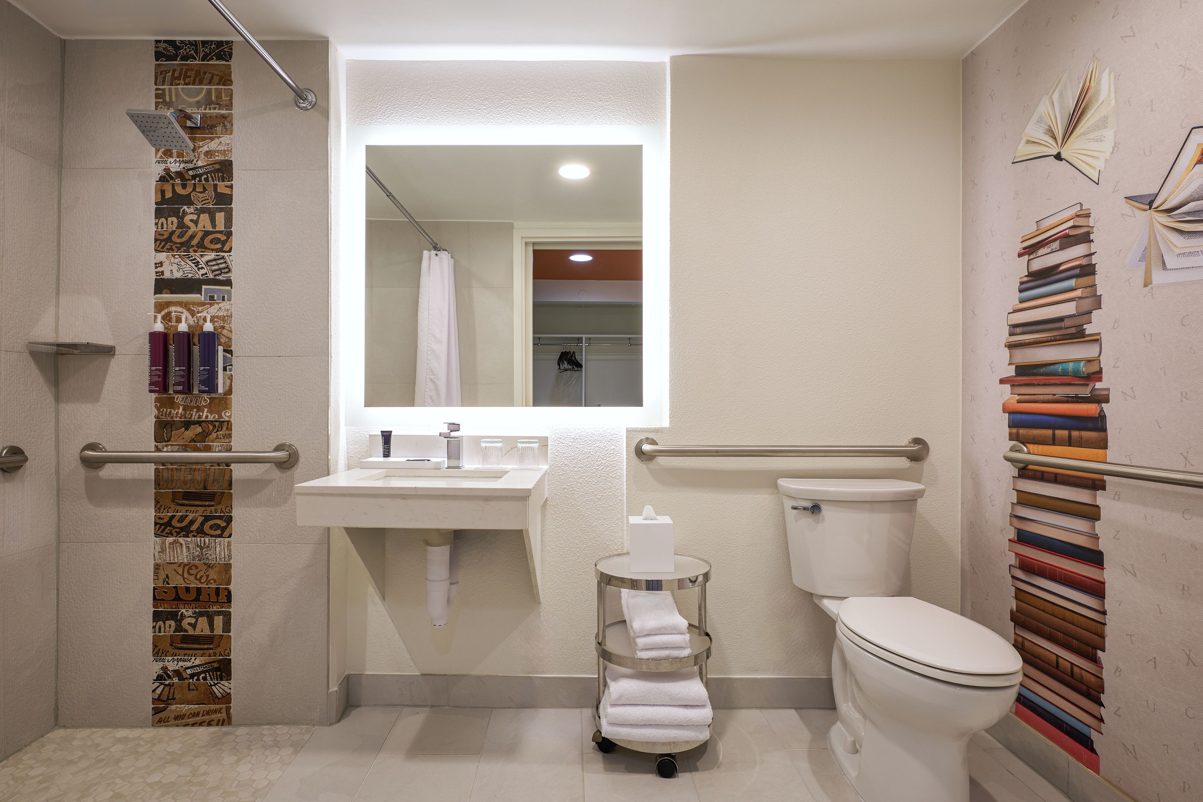 A bathroom with a shower, toilet, sink, and towel rack.