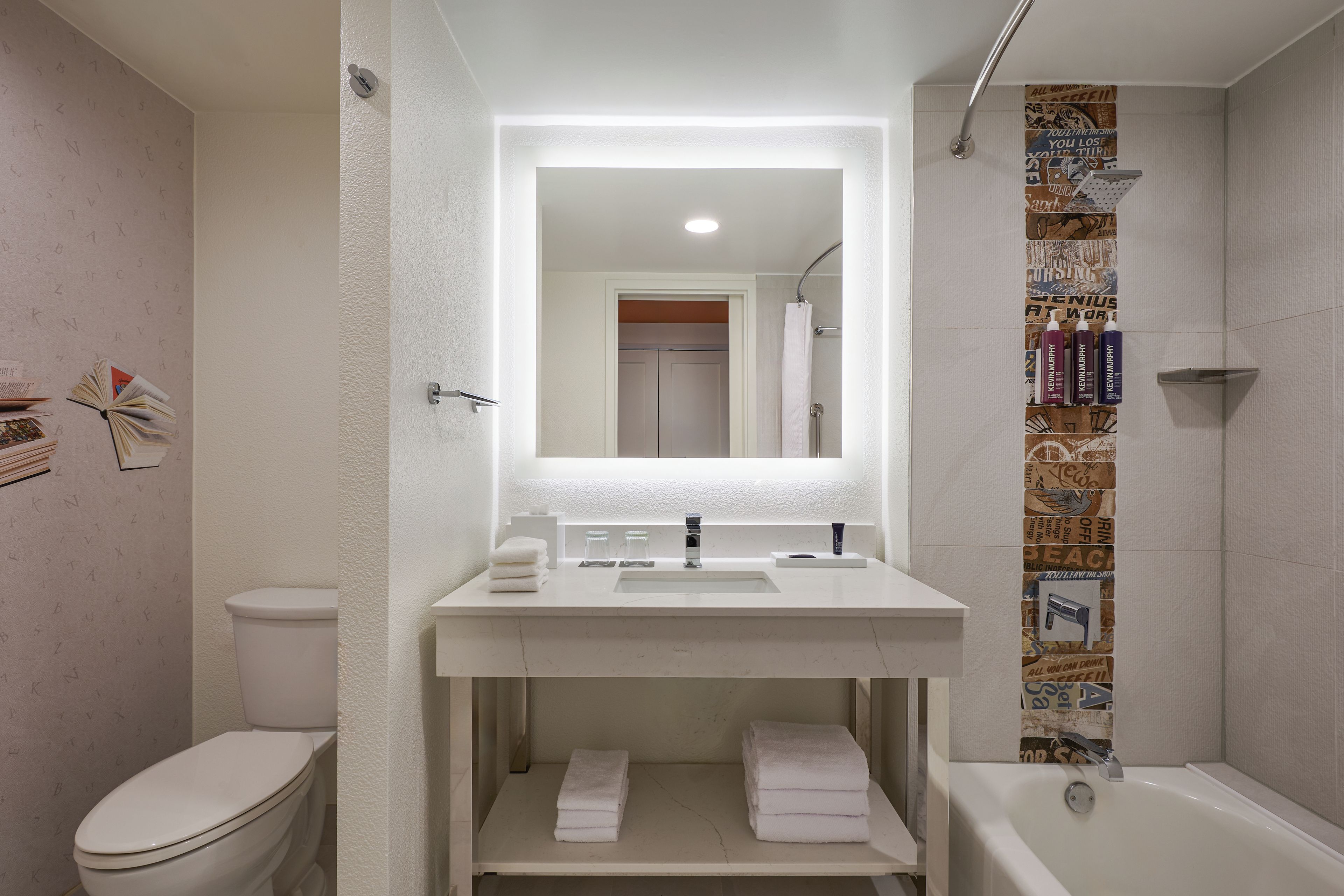 A bathroom with a toilet, sink, and bathtub.