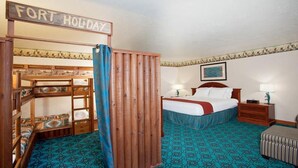 A bedroom with bunk beds, a bed, a nightstand, a lamp, and a sign that reads "FORT HOLIDAY". - Holiday Inn Express Mesa Verde-Cortez by IHG (Cortez)