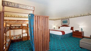 A bedroom with bunk beds, a bed, a nightstand, a lamp, and a sign that reads "FORT HOLIDAY". - Holiday Inn Express Mesa Verde-Cortez by IHG (Cortez)
