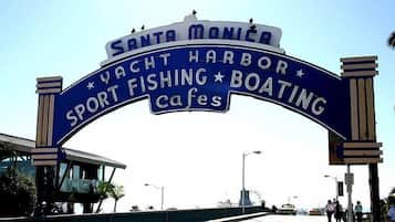 A sign for Santa Monica Yacht Harbor with mentions of sport fishing, boating, and cafes.
