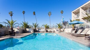A swimming pool with lounge chairs and palm trees. - Hilton Garden Inn Marina Del Rey (Marina del Rey)