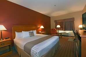 A hotel room with a large bed, two bedside lamps, a desk with a chair, a TV, and a window with curtains. - Best Western Plus The Inn at Horse Heaven (Prosser)