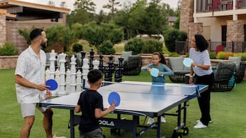Guests can enjoy a game of table tennis in the lush outdoor setting.