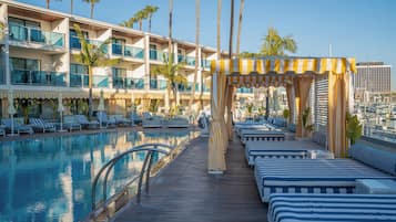 A poolside area with lounge chairs and a cabana.