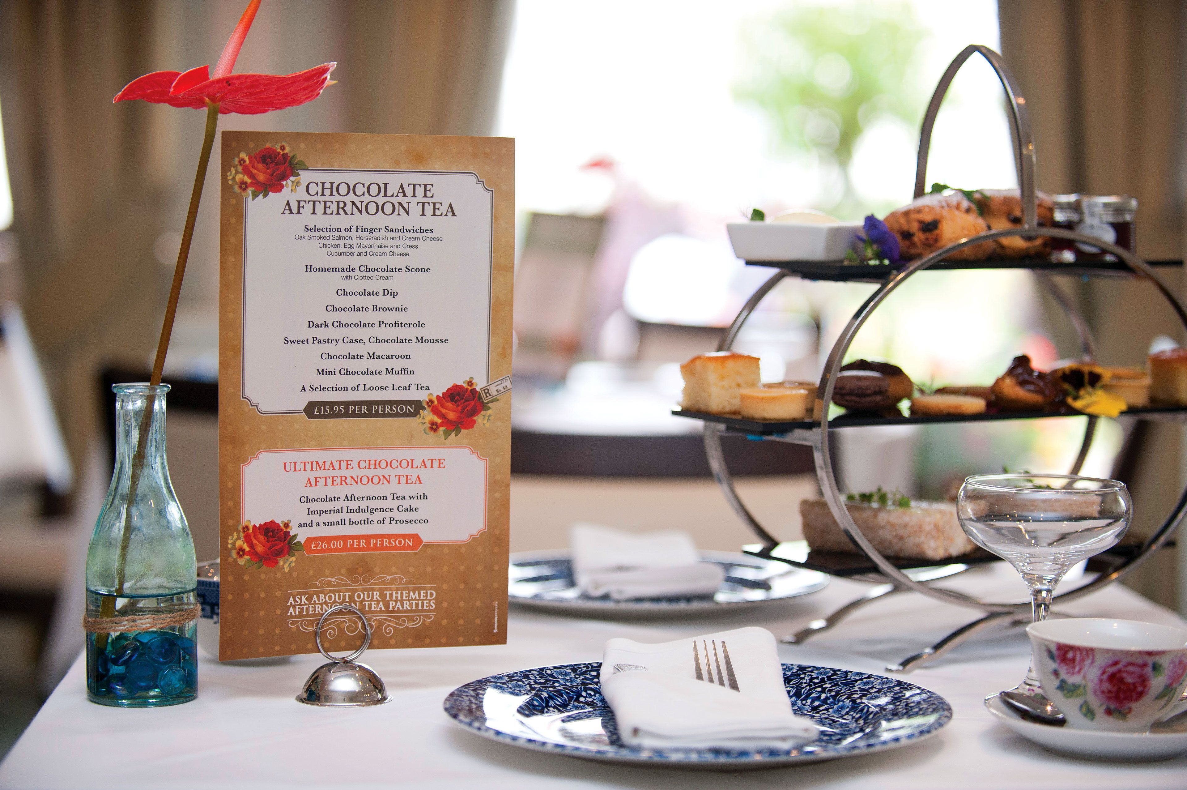 A menu for chocolate afternoon tea with a selection of finger sandwiches and desserts, priced at £15.95 per person.