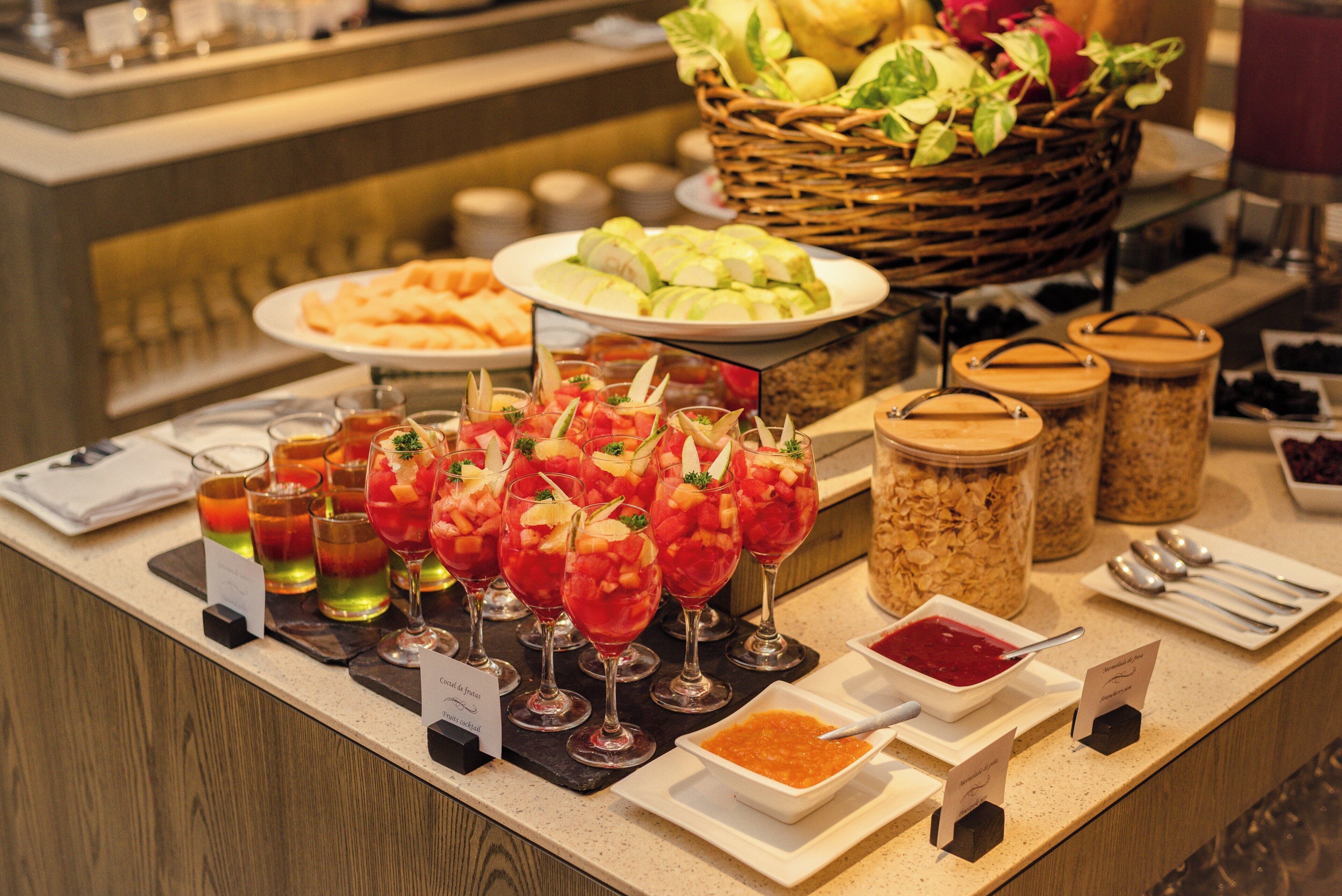 A buffet with various food items and drinks.