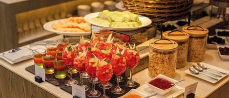 A buffet with various food items and drinks.