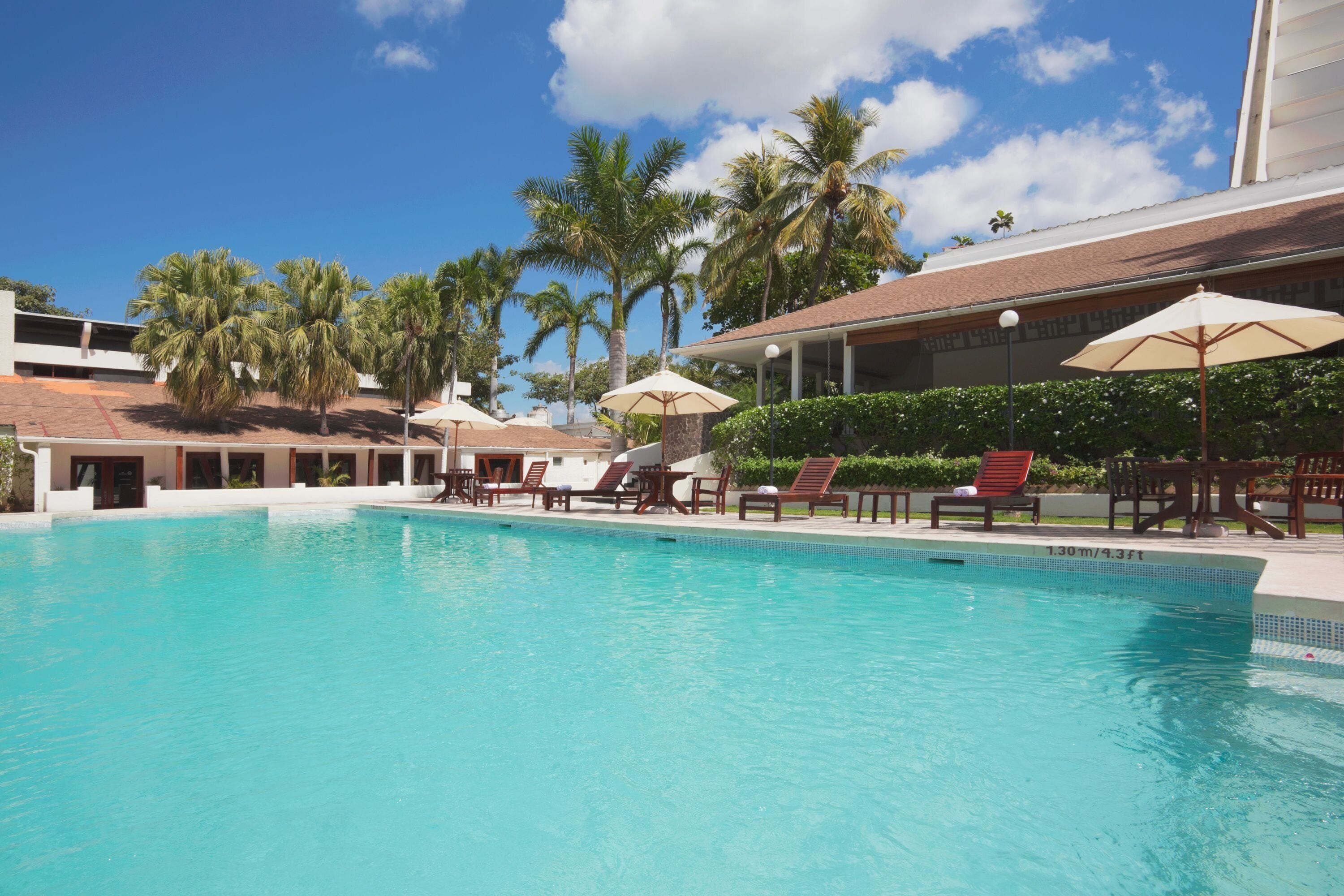 Outdoor pool, open 7:00 AM to 10:00 PM, pool umbrellas, sun loungers