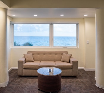 Oceanfront Queen Suite | 1 bedroom, in-room safe, laptop workspace, blackout drapes at Crystal Beach Suites Miami Oceanfront Hotel