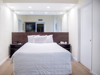Queen Suite | In-room safe, laptop workspace, blackout drapes, iron/ironing board at Crystal Beach Suites Miami Oceanfront Hotel