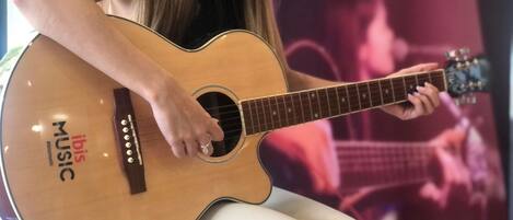 A person playing an acoustic guitar.