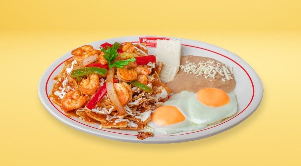 A plate of food with shrimp, vegetables, and a fried egg.