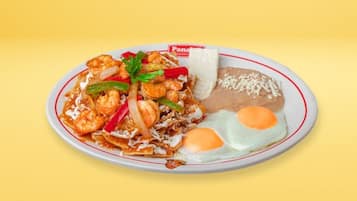 A plate of food with shrimp, vegetables, and a fried egg.