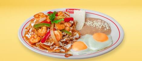 A plate of food with shrimp, vegetables, and a fried egg.