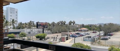 A parking lot with several cars, a Starbucks, and a building with a sign.