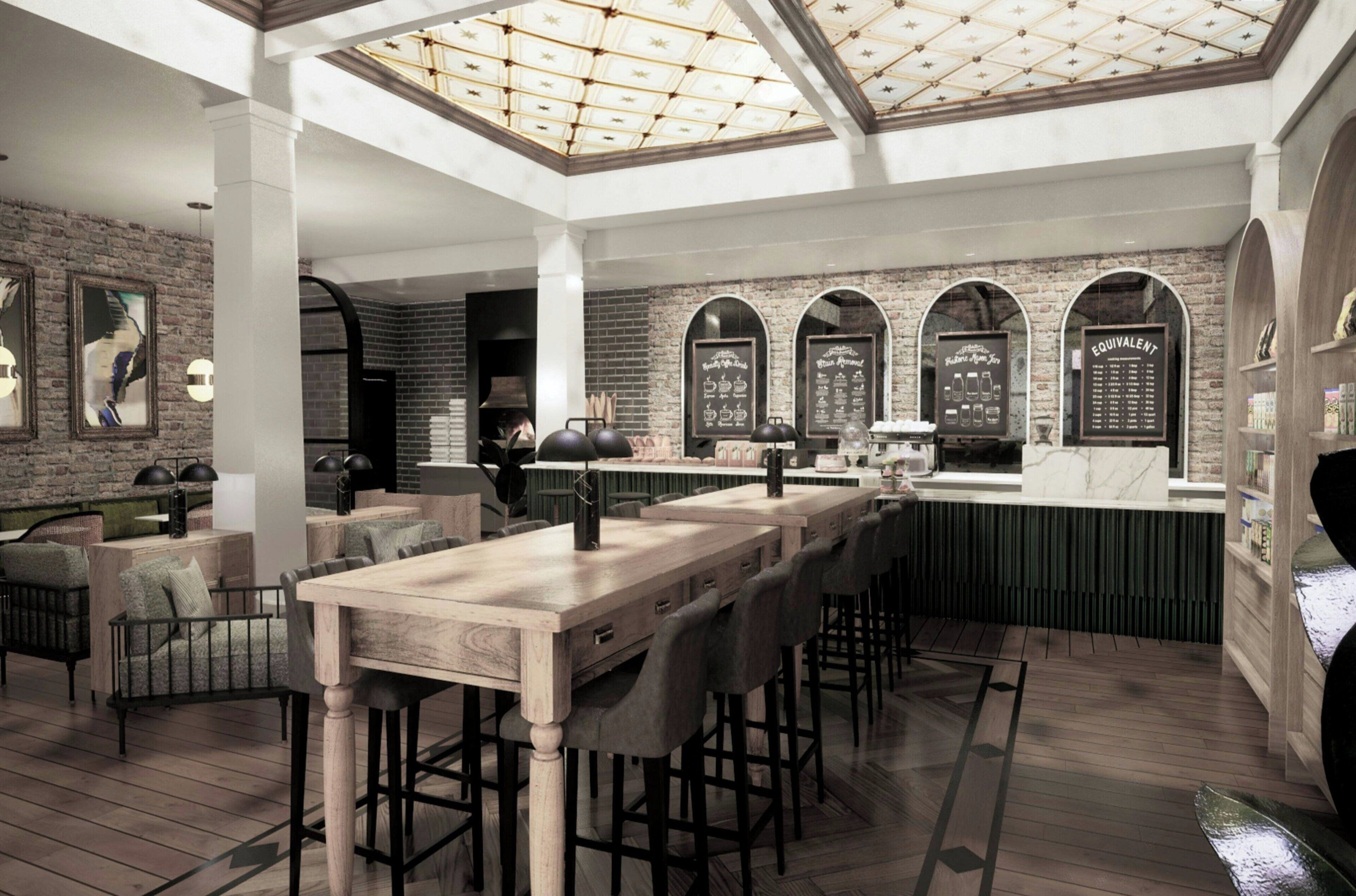 Una cocina espaciosa con una isla grande, taburetes de bar y un techo alto con tragaluces.