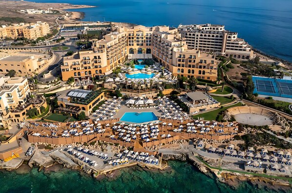 Relax by the pool surrounded by scenic sea views and sun loungers.