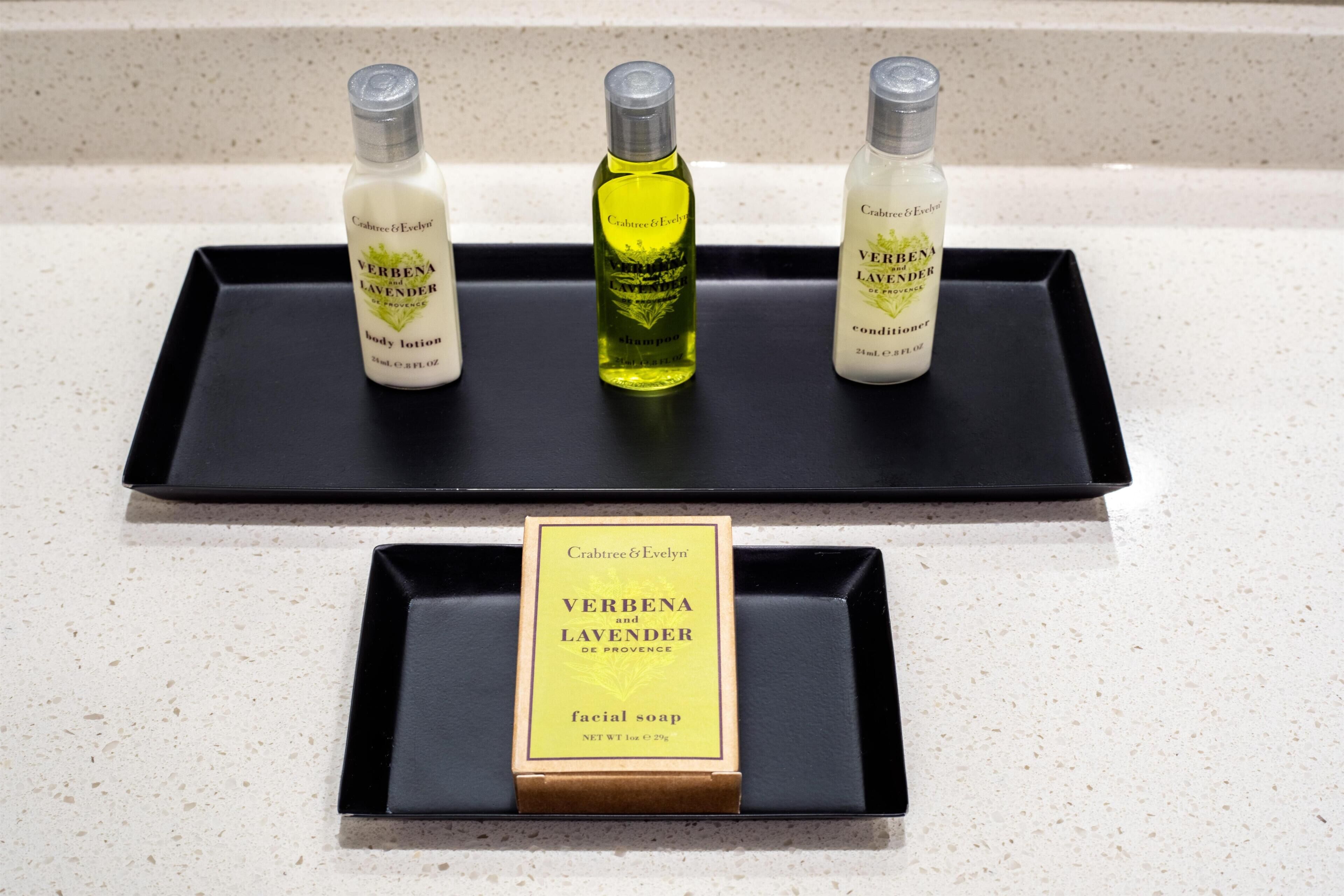Three bottles of Verbenalavender on a black tray, and a box of facial soap below.