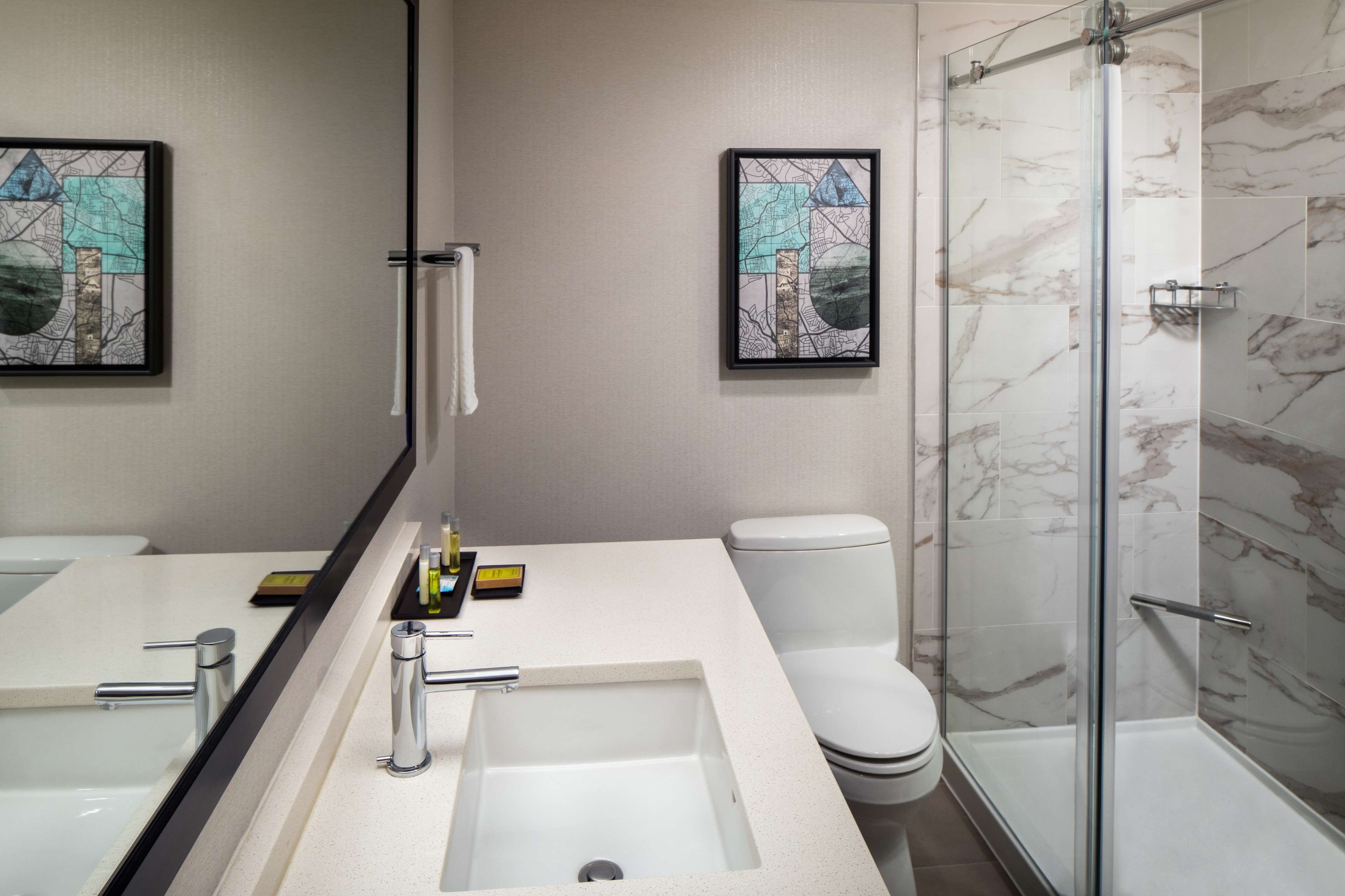 designer toiletries, hair dryer, towels