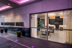 The exterior of The Bethesda Hotel with a modern facade, large windows, and a reception area visible inside. - The Bethesdan Hotel, Tapestry Collection by Hilton (Bethesda)